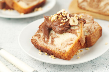 A piece of marble biscuit with chocolate cream and nuts