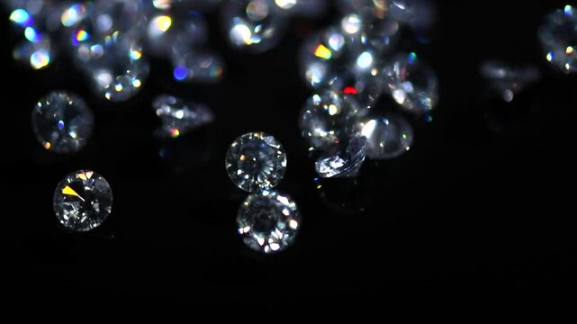 Diamonds rotating on black background, crystals, beautiful shining brilliants sparkling with colorful caustics, rainbow lights. Moissanite. Zirconia. Diamonds sparkle and shimmer on black 