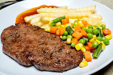 A plate of food with a piece of picanha meat