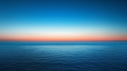 Obraz premium A beautiful blue ocean with a pink and blue sunset sky.