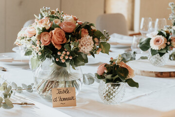 Elegant wedding bouquet  with peach and pink roses,  and greenery, perfect for a romantic bridal arrangement or wedding decor.