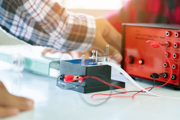 Children are studying the measurement of friction force with a spring balance using a small...