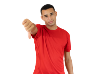 Young man in red t-shirt with thumb down over transparent background