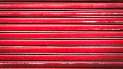 A vibrant red metal rolling door showcasing durability and strength, perfect for industrial and commercial environments. This image represents protection.