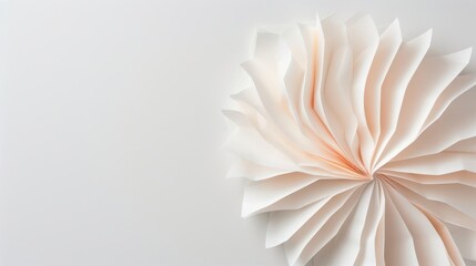 Obraz premium Delicate paper sculpture, intricate layers fan out harmoniously, elegant design evokes grace, minimalist background enhances focus on the artistry of the folded paper.