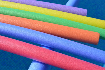 close up of colourful pool noodles
