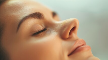 Close-up of a serene face with closed eyes, conveying tranquility and peacefulness. Perfect for wellness and relaxation themes.
