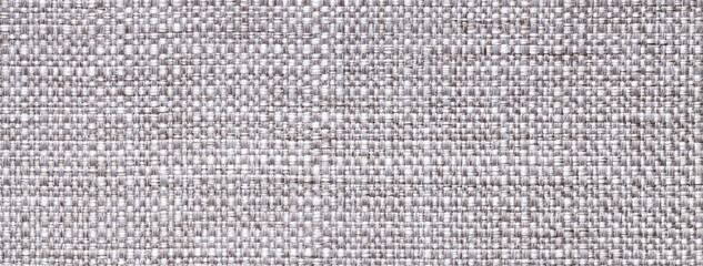 Texture light gray background from woven textile material with wicker pattern, macro. Vintage silver fabric
