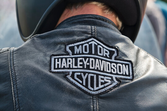 Embroidered Harley-Davidson Motor Cycles logo on the back of a biker's leather jacket. Harley Davidson or Harley is an American motorcycle manufacturer.
