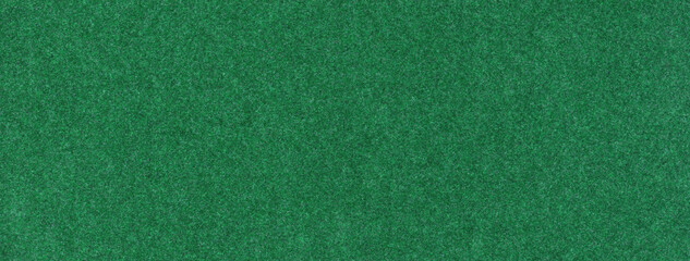 Texture dark green background from felt textile material, macro. Structure vintage emerald fabric cloth
