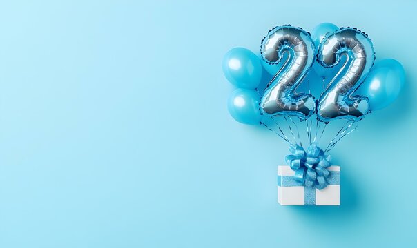 Happy birthday 22th with blue foil balloons and gift box on color background