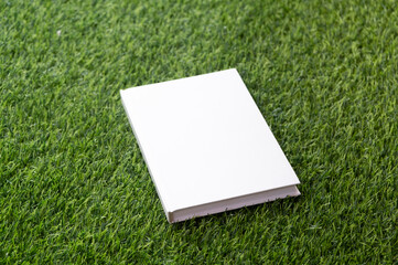 Mockup book on green grass background