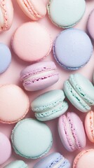 Obraz premium Pastel-colored macarons in various shades, arranged closely together, perfect for smartphone wallpaper.