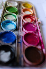 A beautifully colorful watercolor palette that showcases a variety of paint colors ideal for any artistic creations