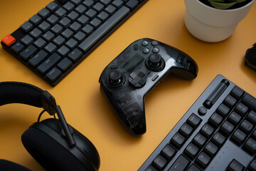 gamer work space concept, top view a gaming gear, mouse, keyboard, joystick, headset   on table background.