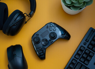 gamer work space concept, top view a gaming gear, mouse, keyboard, joystick, headset   on table background.