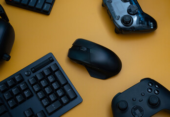 gamer work space concept, top view a gaming gear, mouse, keyboard, joystick, headset   on table background.