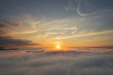 Aerial landscape over the clouds, at sunrise
