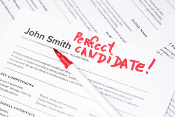 Fake mock CV (curriculum vitae) resume for John Smith, selected by HR as the perfect candidate for a job. Concept of job search, employee selection, recruitment process, work and hiring.