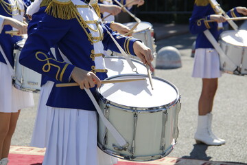 A drummer in uniform plays at a party