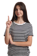 Portrait of cute teenage girl pointing at something on white background