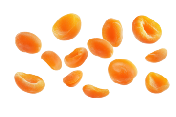 Fresh apricot kernels scattered on a clean surface, showcasing their vibrant orange color and unique texture, perfect for healthy recipes.