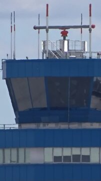 heavily zoomed-in close-up control tower airport, showing intricate soft airport management tower lighting tower structure airport landmark backlit close up architecture