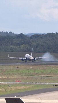 landing generic airplane visible touchdown smoke airport front view intensity aircraft makes contact airplane landing international airport aviation operations runway landing