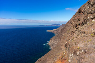 View of the Atlantic Ocean and the rocky steep coast from the observation deck - Mirador de Balcon. Gran Canaria. Canary Islands. Spain.