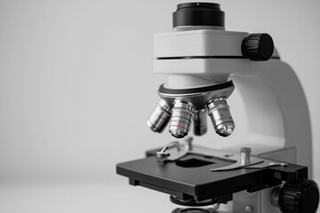 Fototapeta premium Close-up of a microscope showcasing its lenses and stage, ideal for scientific research and educational materials.