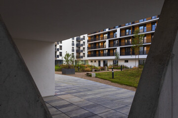 Modern living building with park, bench and trees. Downtown czech real estate, housing background