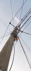 Electric poles towering high with tangled cables