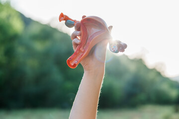 Hand holding anatomical model of uterus at dawn
