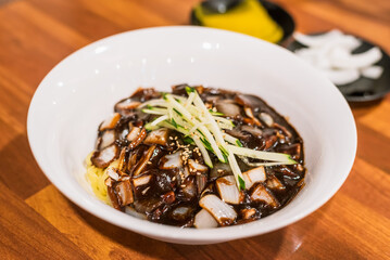 Close-up of Jajangmyeon with Blurred Pickled Radish and Onion in Korean Chinese Restaurant