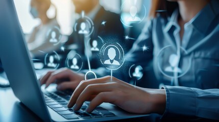 A woman is typing on a laptop with a screen that has a lot of people on it