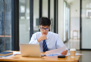 Businessman Analyzing Risk, Investment, and Market Data in the Office