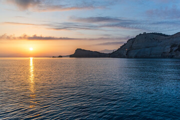 Evening landscape with sea, sky, land and sunset