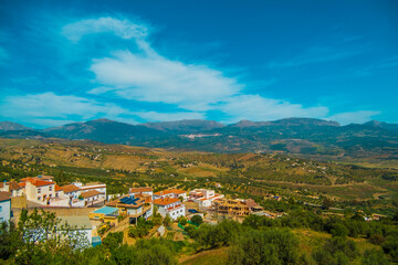 Fototapeta premium Beautiful view of a Spanish village in the interior of Andalucia with mountains in the background