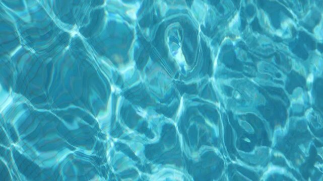 Blue water in the swimming pool with light sun reflections. Swimming pool with blue clear water, sea, travel, summer
