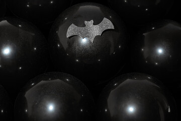 Black balloons with water drops and cutout bat Halloween sale party background