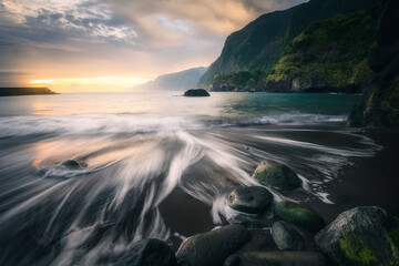 Dramatic colorful sunrise at Seixal beach in Madeira, Portugal