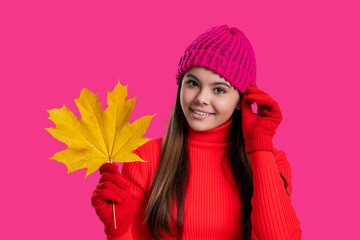 Autumn leaf arrangement. Girl with maple leaf wear hat. Fall season beauty. Autumn style. Fallen autumn leaves. September season. Stylish teen girl isolated on pink with maple leaf. Yellow foliage