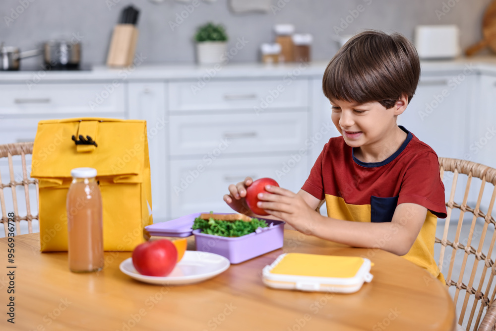 Canvas Prints Cute boy with lunch box, healthy products and bag at wooden table in kitchen