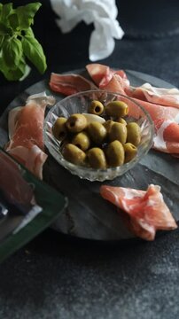 meat plate and olives different types of meat salami, prosciutto, sausage, coppa natural food fresh appetizer meal food snack on the table copy space food background rustic top view