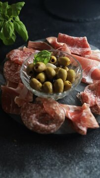 meat plate and olives different types of meat salami, prosciutto, sausage, coppa natural food fresh appetizer meal food snack on the table copy space food background rustic top view