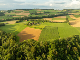 Aerial view of rural landscape with farmland in Switzerland. Pattern of fields.