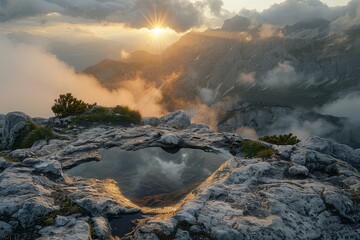 Fototapeta premium Misty morning view from El Nino in SIRDORLD with sun rays through mountains and puddle on a cliff edge