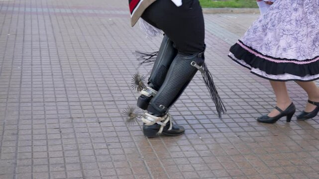 View of feet of a couple of huasos dancing cueca outside, concept of celebrating national holidays
