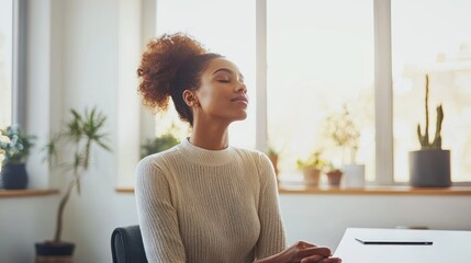A woman sitting at a desk, taking a deep breath and planning her tasks for the day, representing the concept of pacing oneself