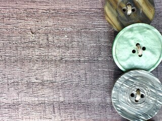 colored buttons on brown wooden background